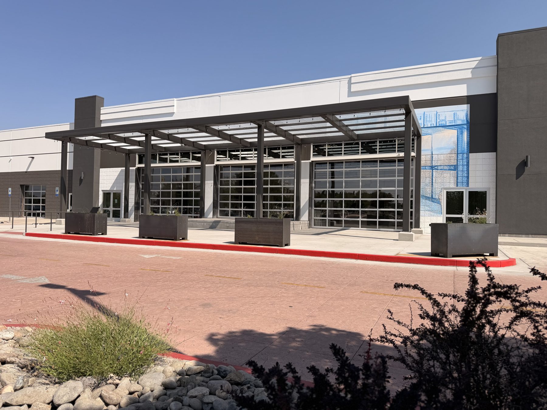 Now: the new steel canopy, glass garage doors and front patio